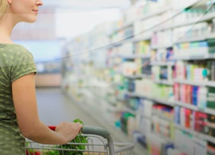 woman looking for the right laxative at the store