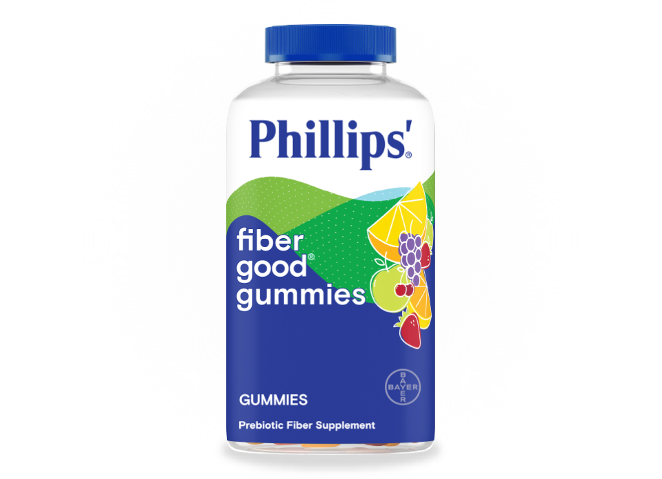 A bottle of Phillips'® fiber good® gummies, and the label features fruit illustrations with text indicating a prebiotic fiber supplement.